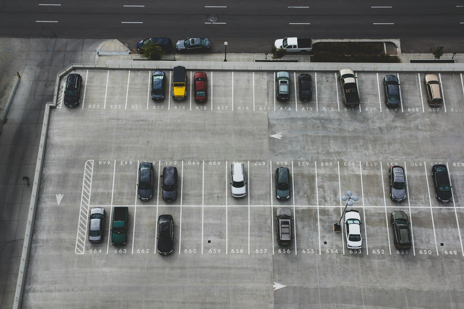 A fleet of rental vehicles lined up on a forecourt